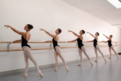 ballet dancer on wall mounted ballet barres.