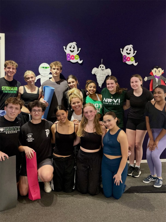 Ballerina performing a high leap in a bright dance studio with Stagestep flooring 

Caption: The perfect foundation for movement: Stagestep flooring, trusted by the best dance studios in the US. 